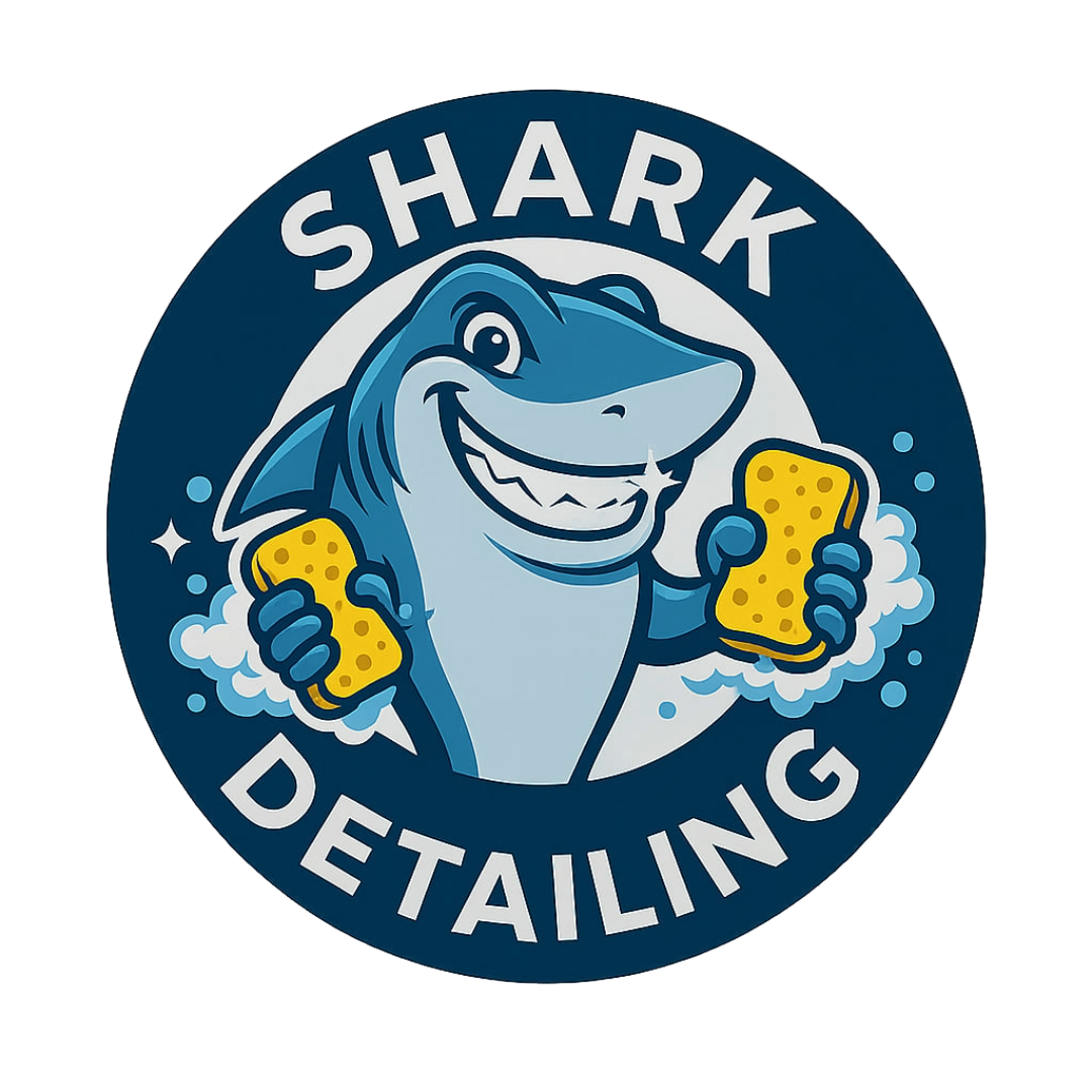 Cartoon shark holding soapy sponges with a shiny tooth – Shark Detailing logo